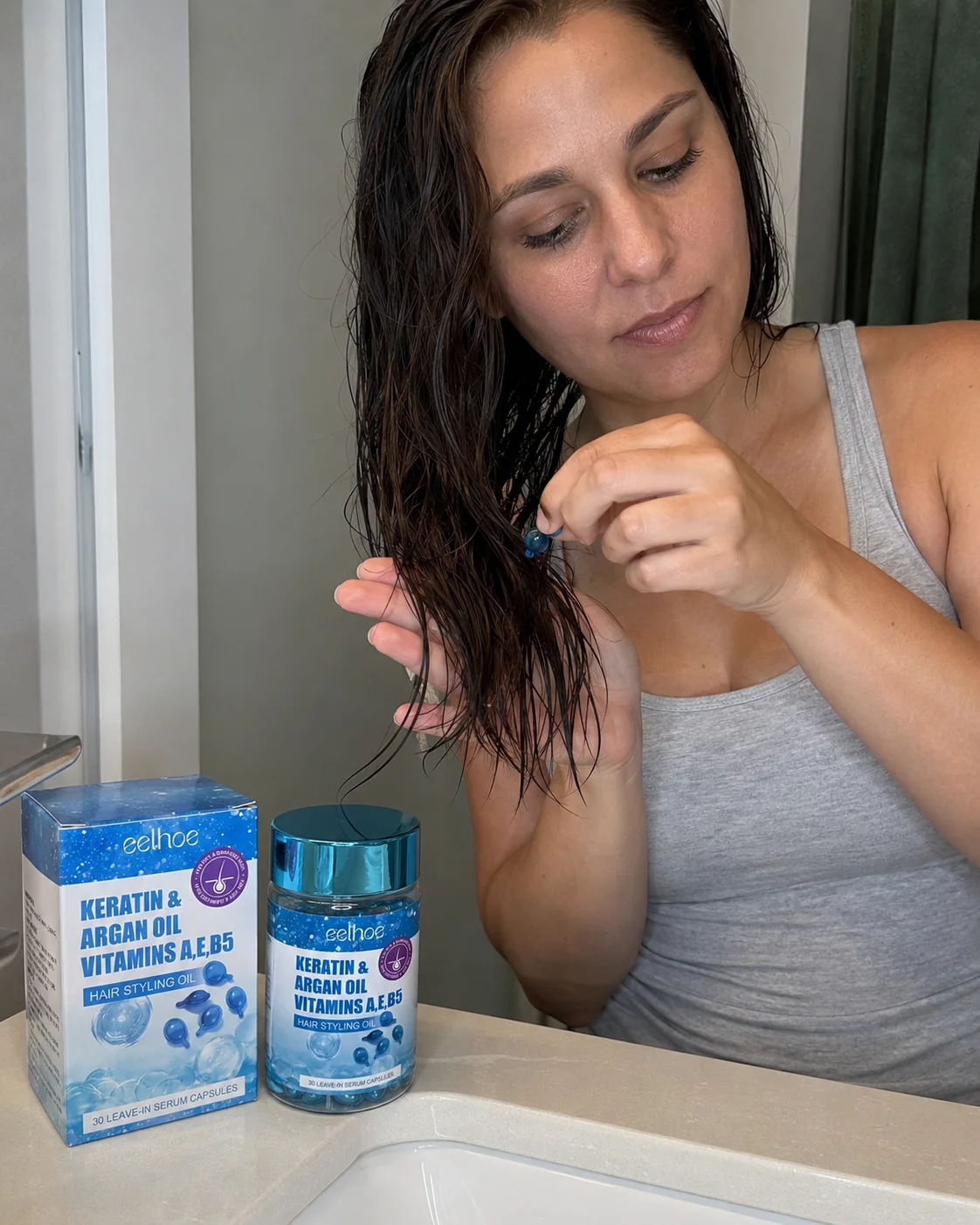 Applying one serum capsule to damp hair with the product box and bottle nearby